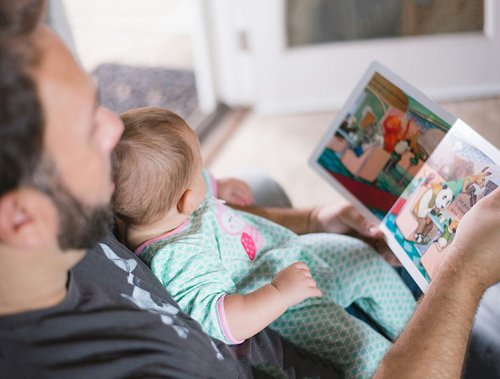 Dad reading to baby